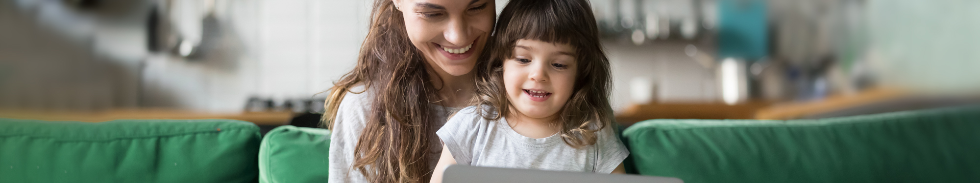 woman and daughter looking at a computer together