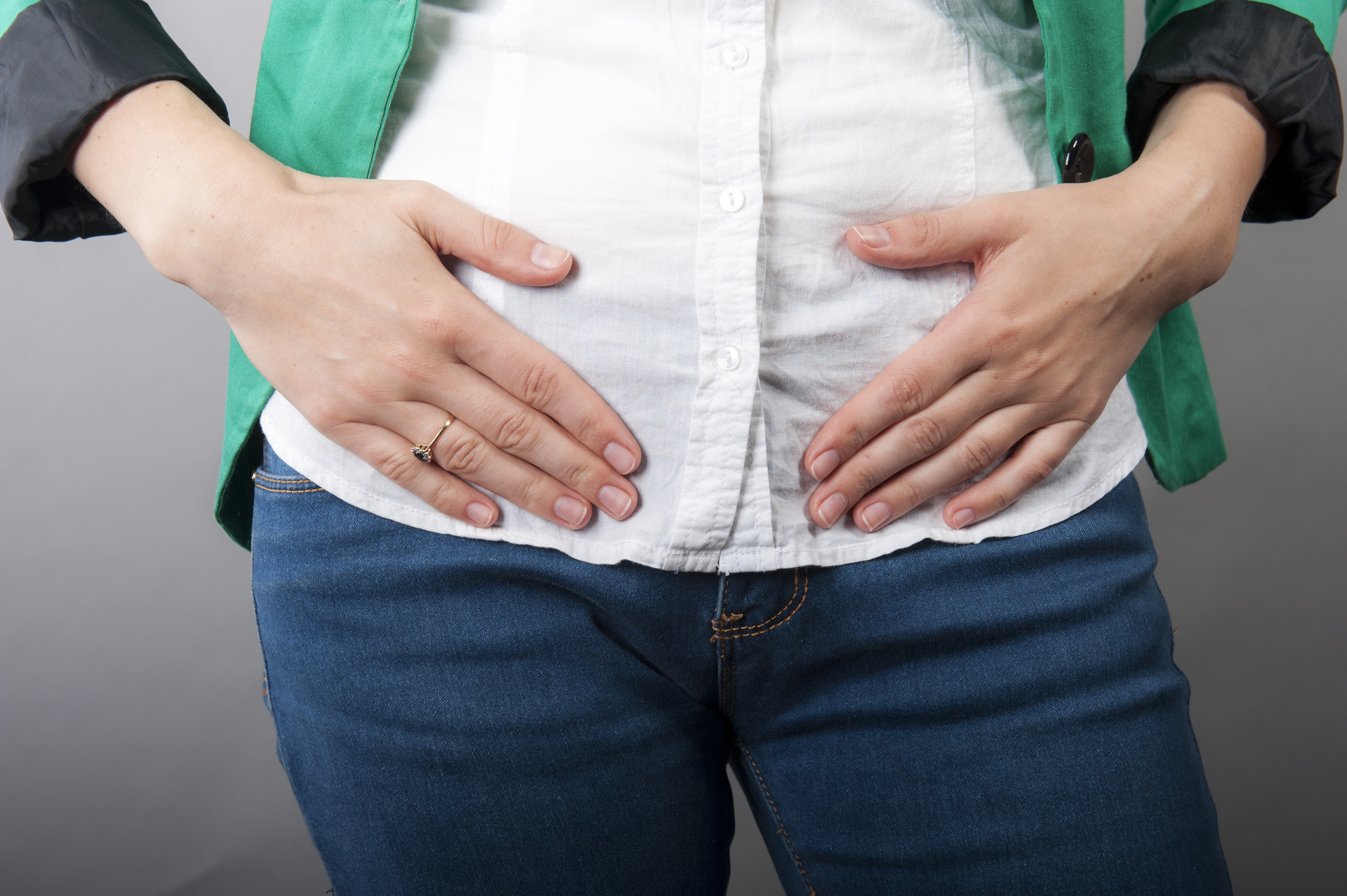 woman holding stomach in pain